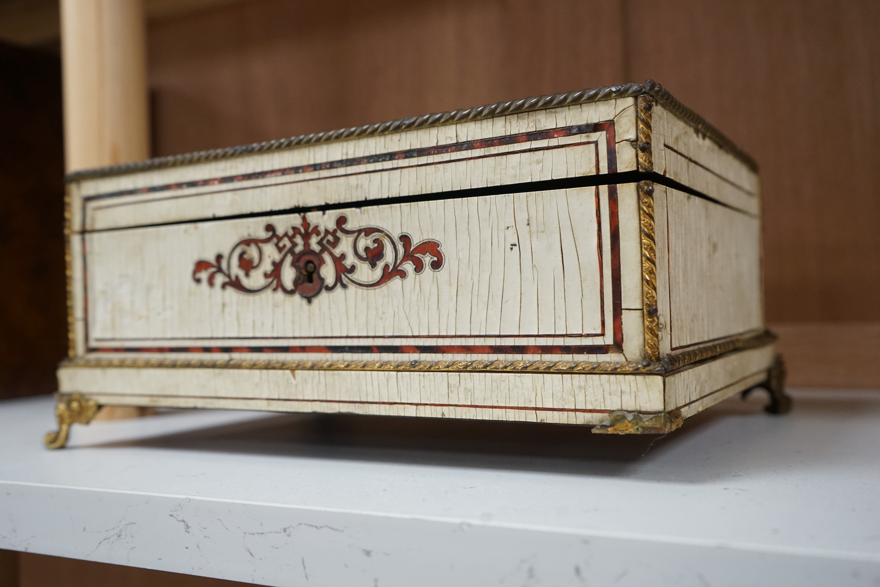 A 19th-century French tortoiseshell and faux lacquer work box, 24.5cm wide x 11.5cm high. Condition - poor to fair